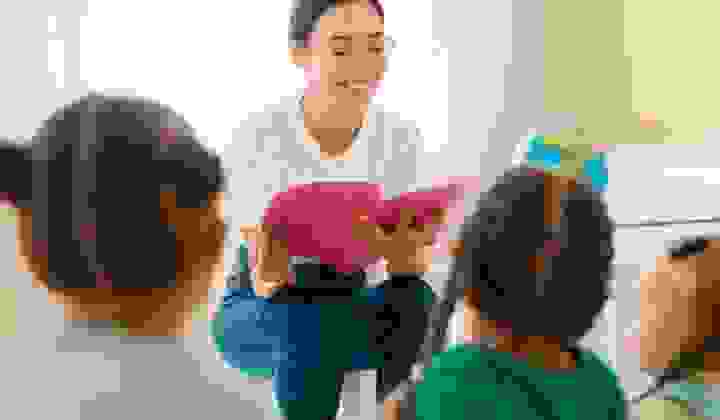 Woman reading book in school