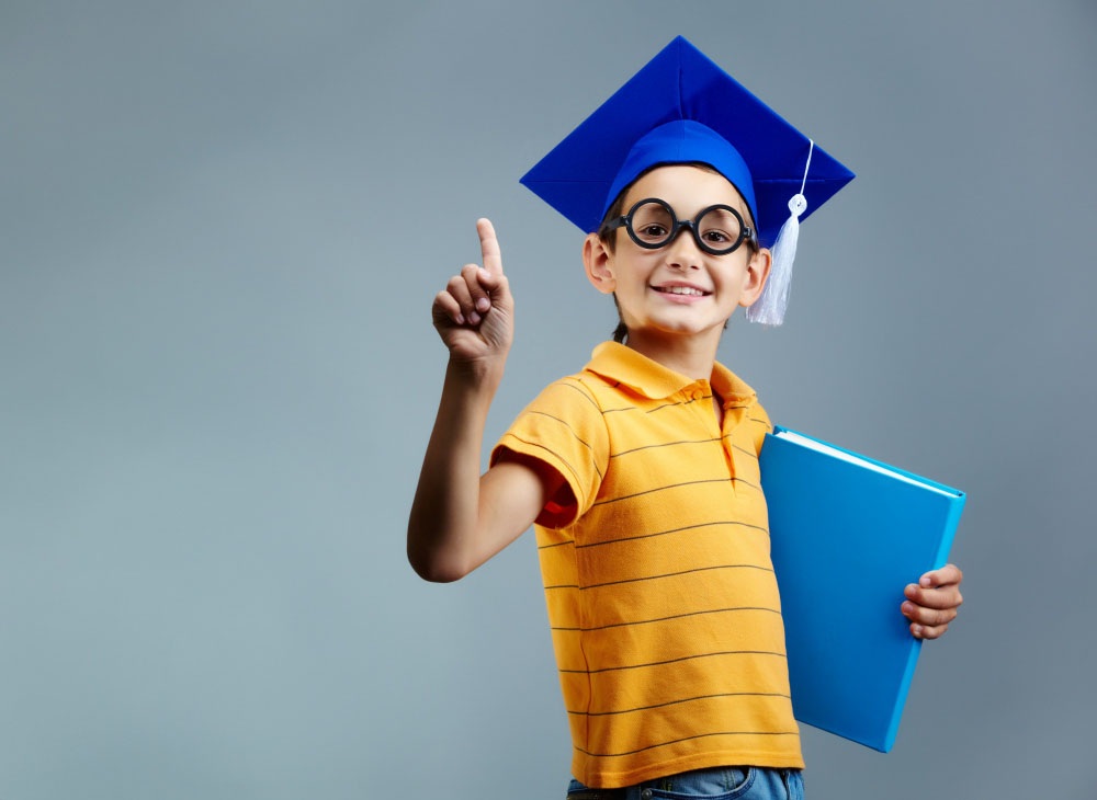 student with glasses and graduation cap